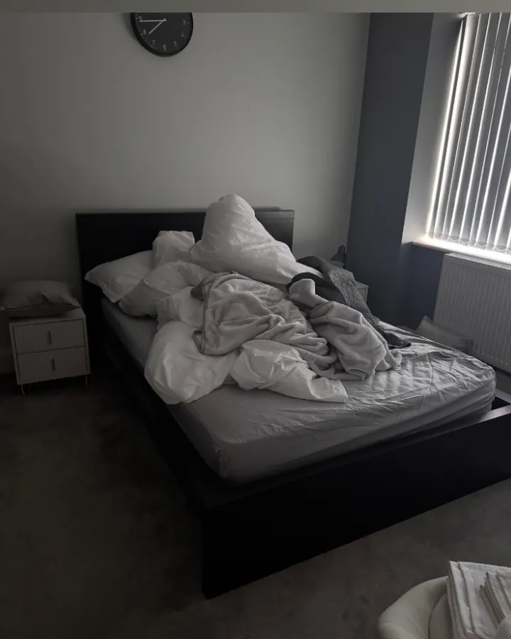Unmade bed and messy bedroom after guests checked out