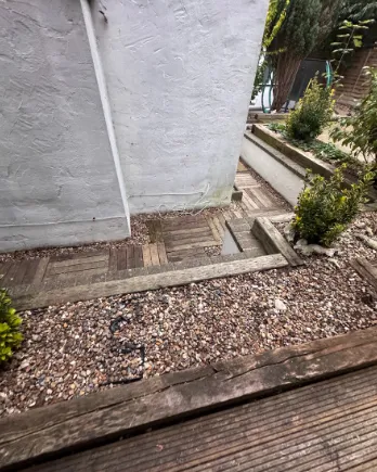 The same corner with a clean gravel bed and edging