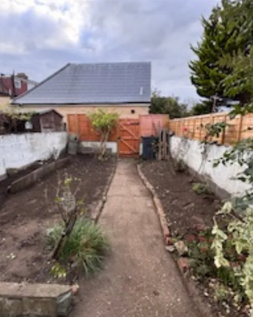 The same path clear, with tidy beds either side