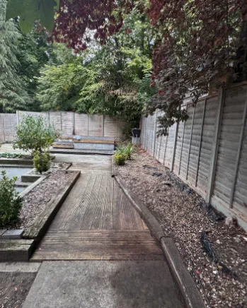 Narrow side garden cleared of leaves and debris